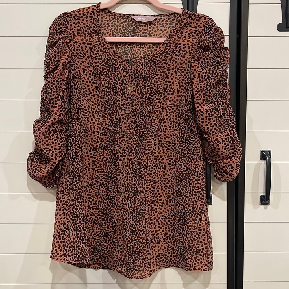 Animal print blouse with roughing in the sleeves. Buttons down the front.